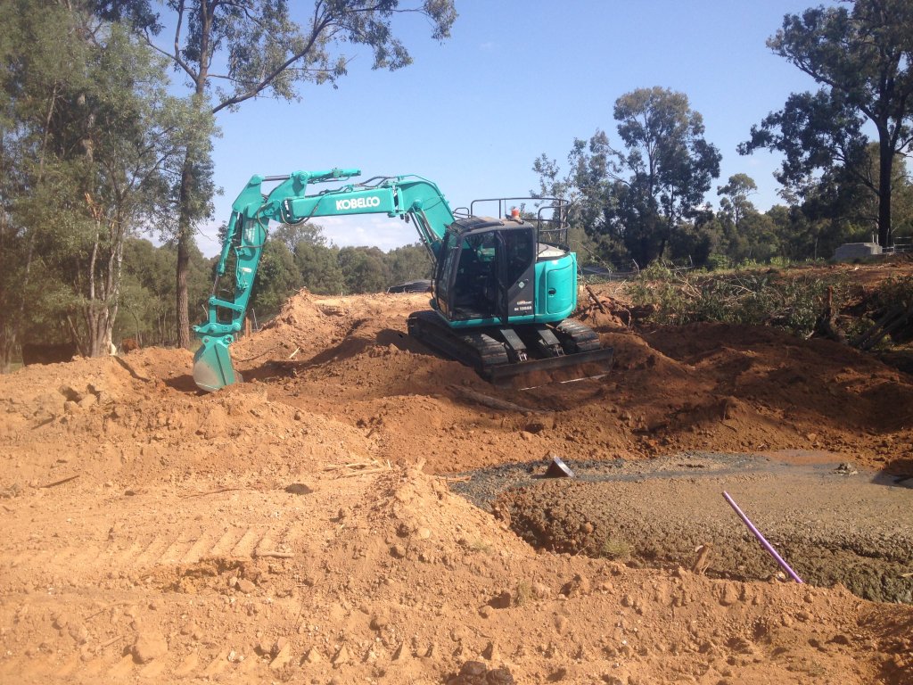 Closing in a dam with an excavator.